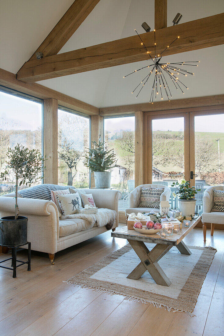 White sofa and chairs in windows of timber framed West Sussex farmhouse renovation UK