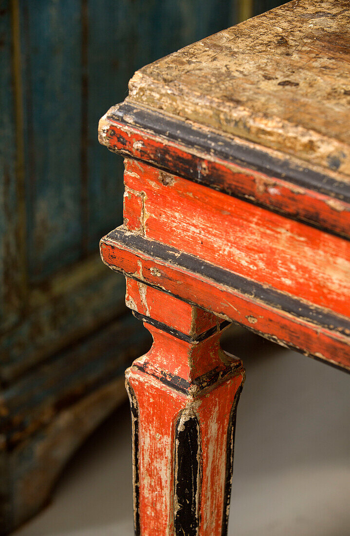 Corner of worn painted chair in South London schoolhouse conversion UK