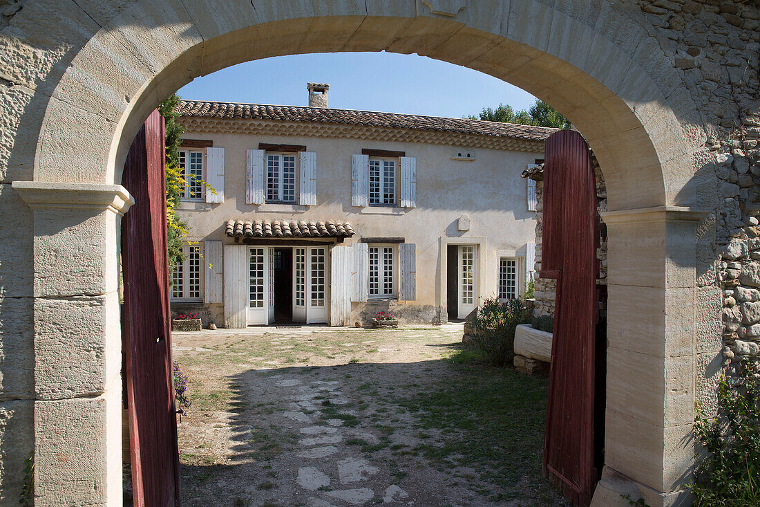 View through arched gateway to 19th century Provencal farmhouse France