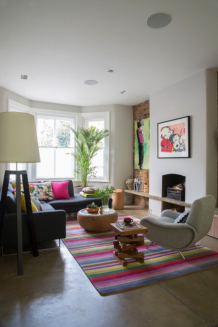 Large lamp and striped rug in living room of Victorian London townhouse UK