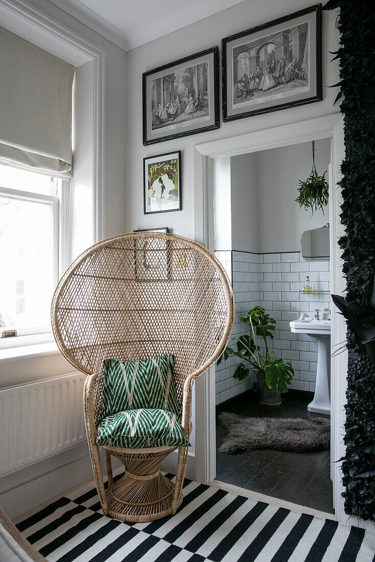 Wicker chair with black and white striped rug in doorway of Hove apartment East Sussex UK