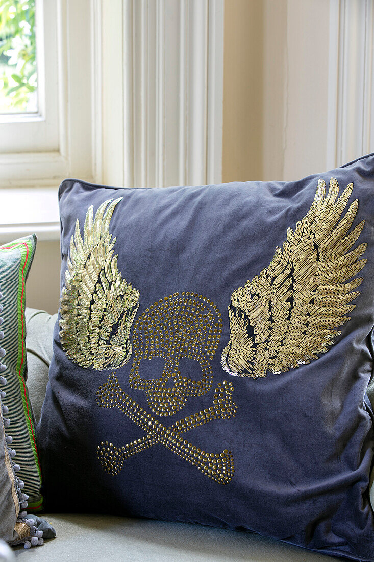 Winged skull and crossbones on cushion in detached Kent home UK