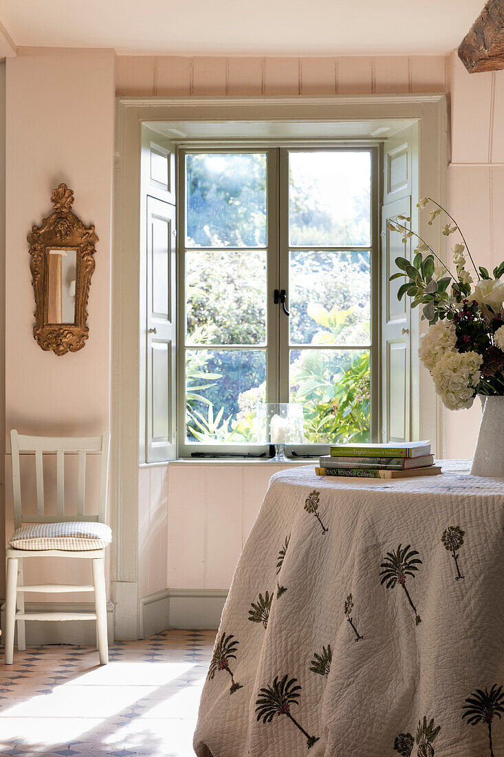 Quilted tablecloth at sunlit window in Somerset home UK