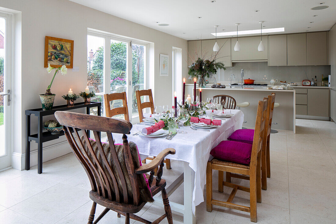 Dining table and chairs in stone floored open plan extension of East Dulwich home London UK