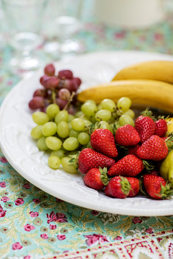 Grapes and strawberries on plate in Hampshire home UK