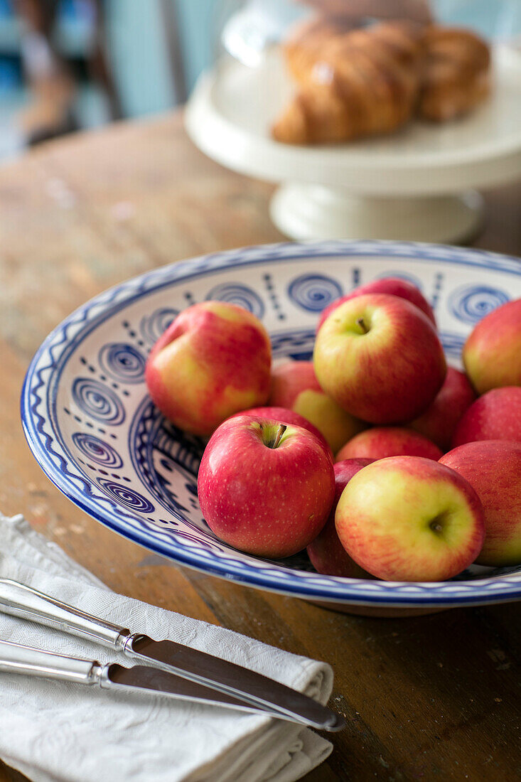 Red apples in ceramic bowl on table in Kent cottage UK