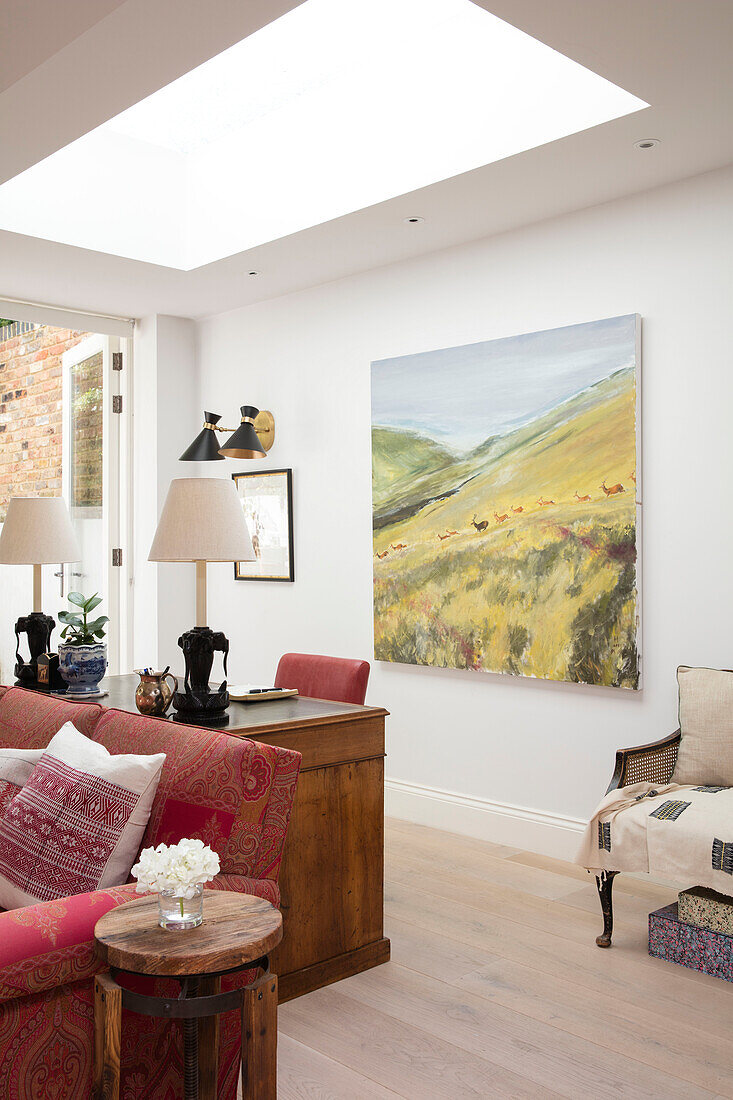 Large art canvas and desk below skylight in extension of North London apartment UK