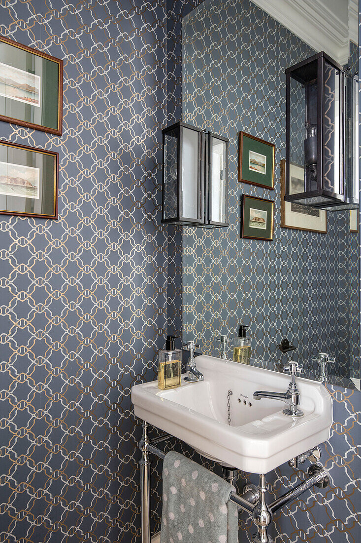 Aladdin wallpaper with mirror above basin in North London apartment UK