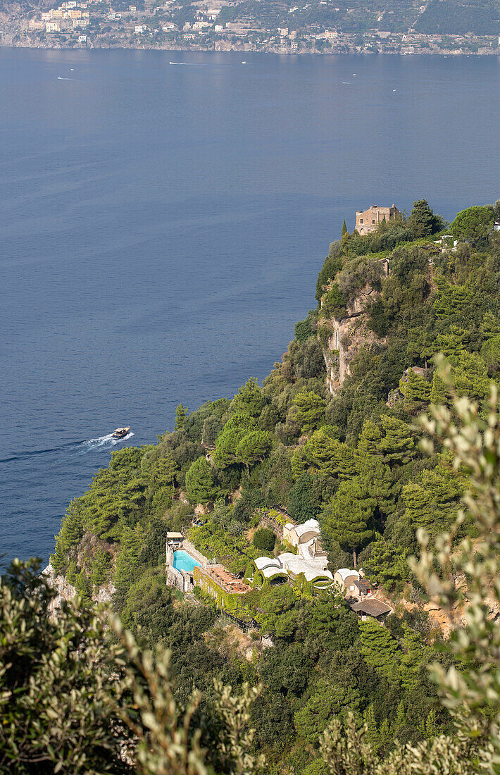 Motor boat and headland on the Amalfi coastline Italy