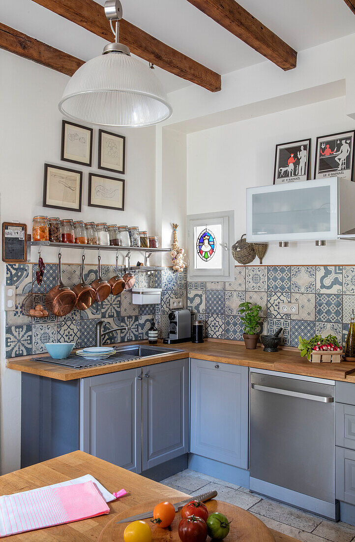 Light grey kitchen units with tiled splashback in Issigeac Perigord France