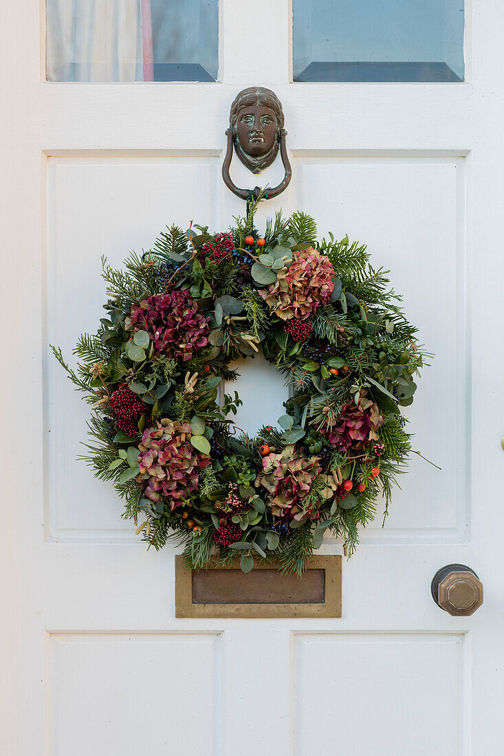 Christmas wreath on front door of Norfolk farmhouse UK