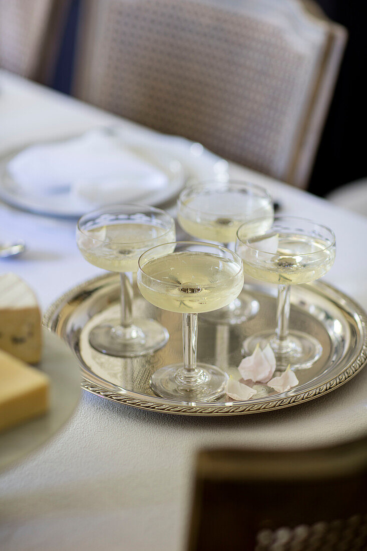 Cocktail glasses on silver tray in Surrey cottage UK