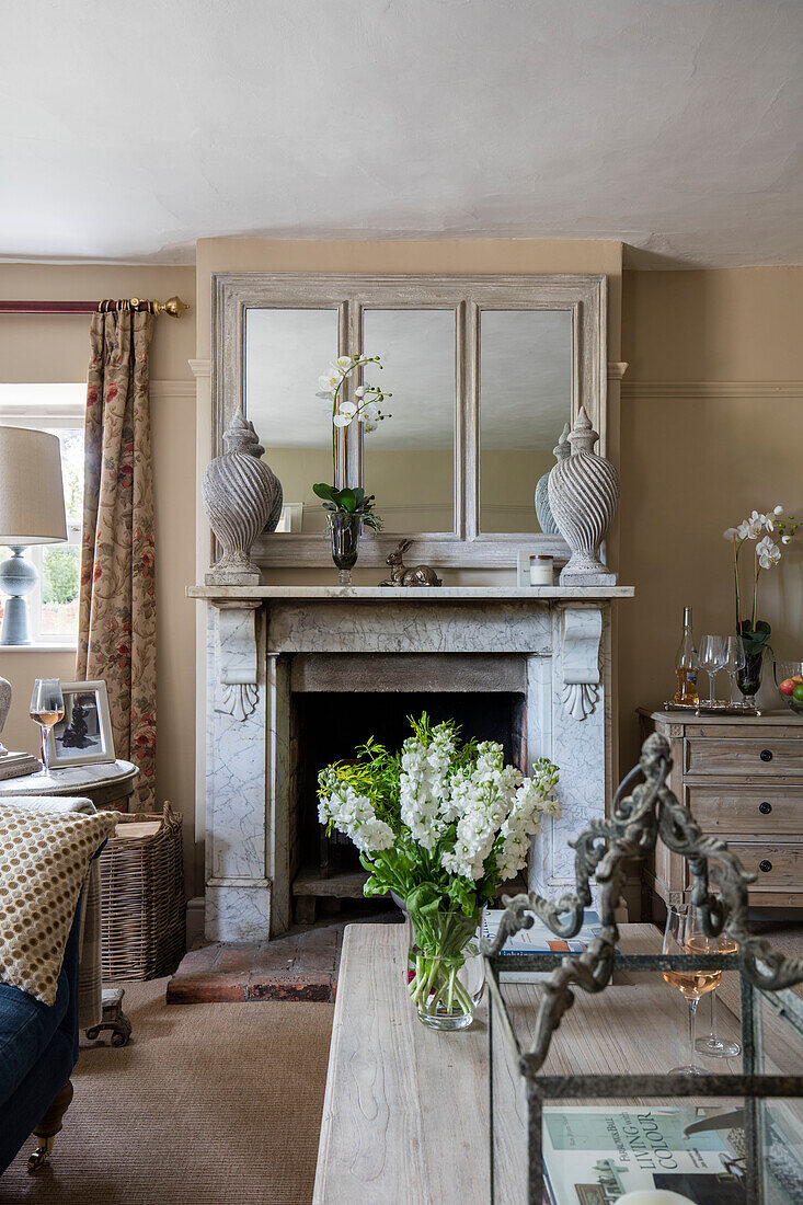 Urns with mirrors on marble fireplace in Grade II listed Georgian farmhouse Somerset, UK