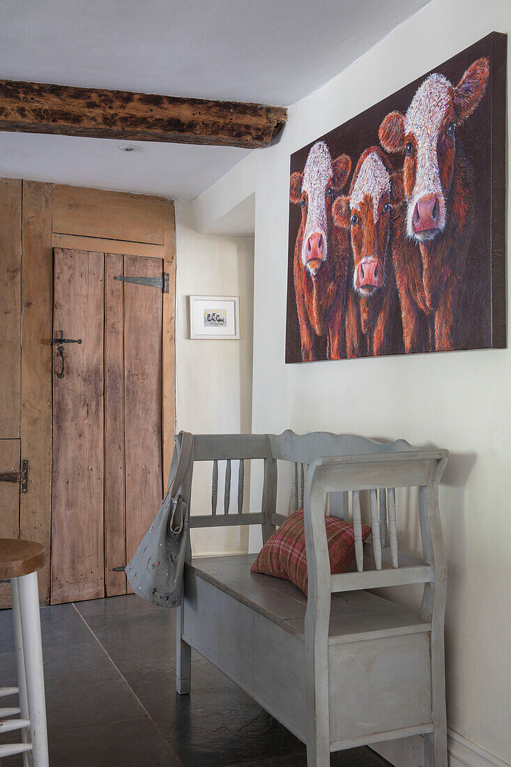 Cow painting above Swedish bench in Grade II listed Georgian farmhouse Somerset, UK