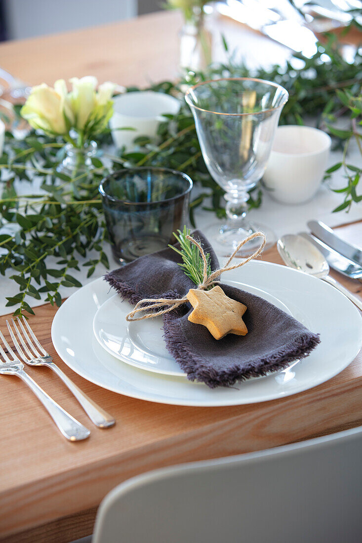 Grey napkin with shortbread biscuit at place setting in 1960s country house West Sussex UK