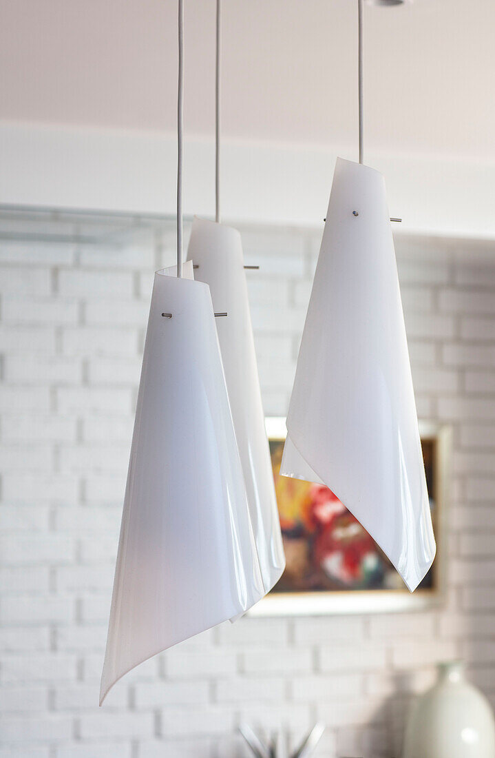 Three modern white pendant shades in London home UK