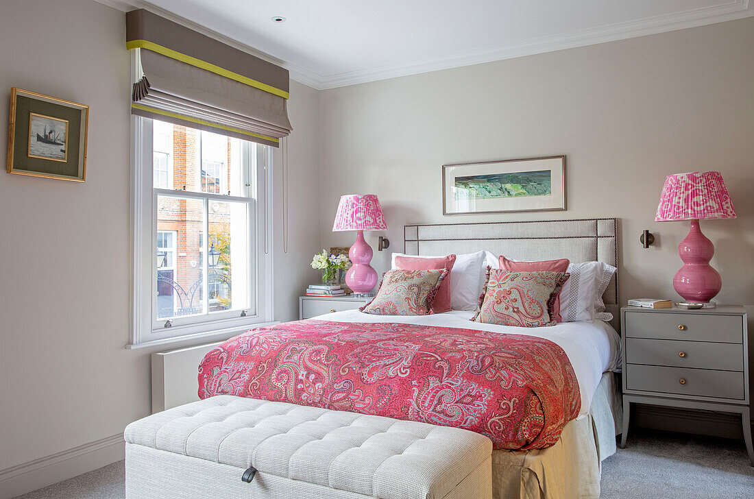 Pink lamps and bed cover London UK