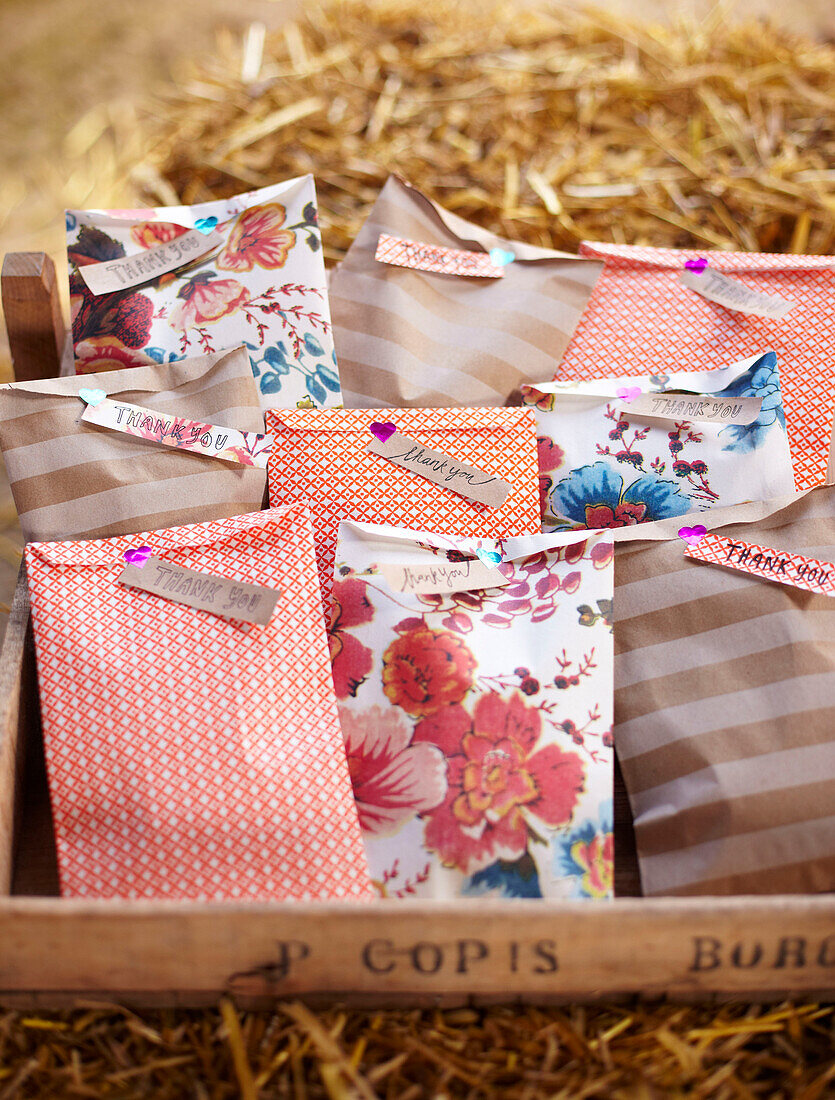 Gift bags with thanks on haybale in late summer