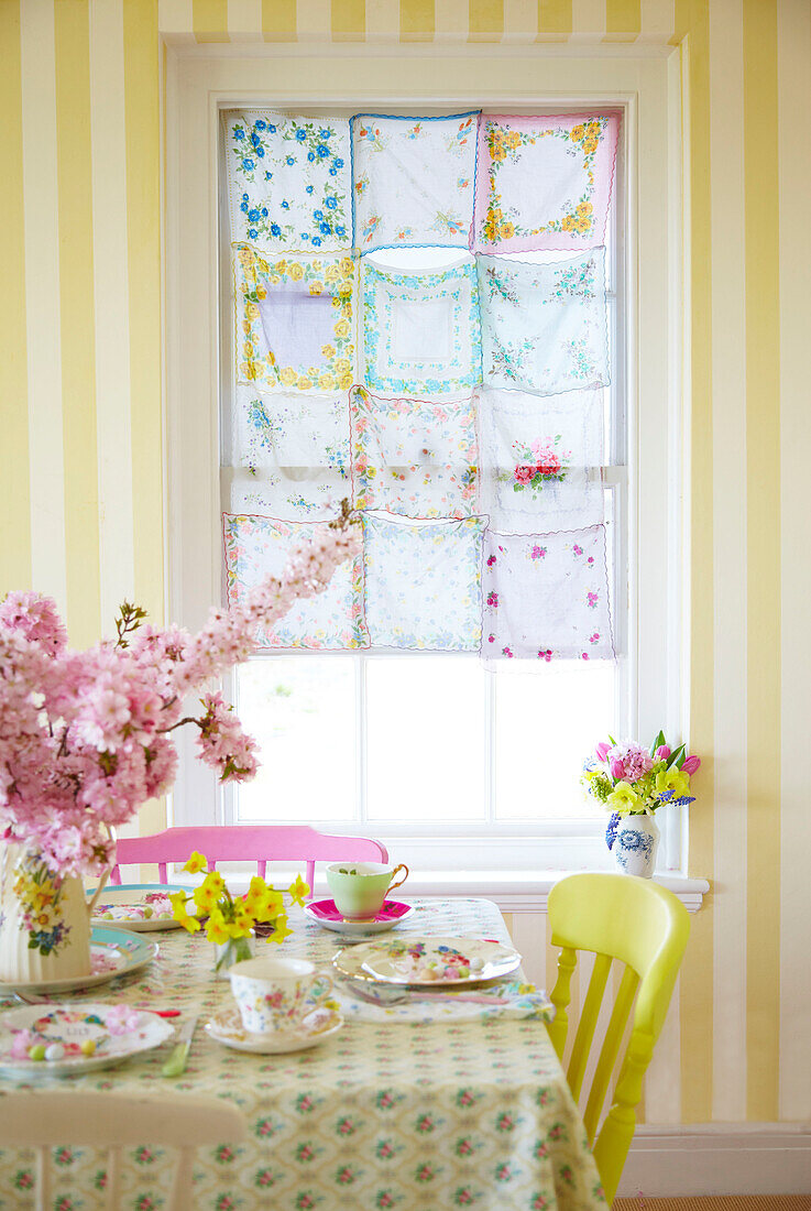 Stitched handkerchiefs at window with table set for Easter