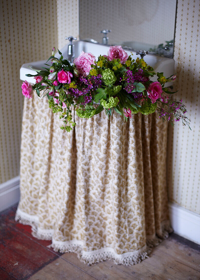 Vintage Blooms - Cut flowers in a hand basin with a vintage curtain and wallpaper