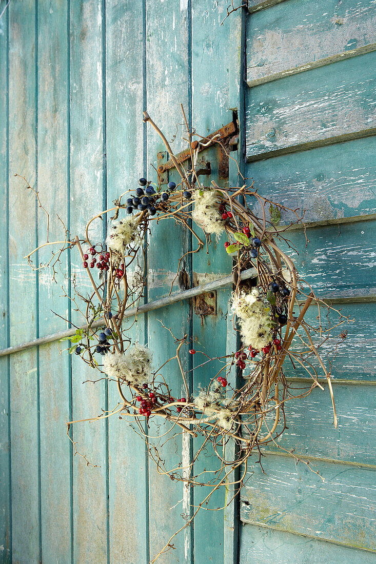 Autumn wreath on weathered outhouse Isle of Wight, UK