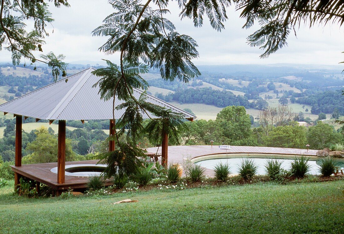 Garden with hot tub and swimming pool and a view over countryside