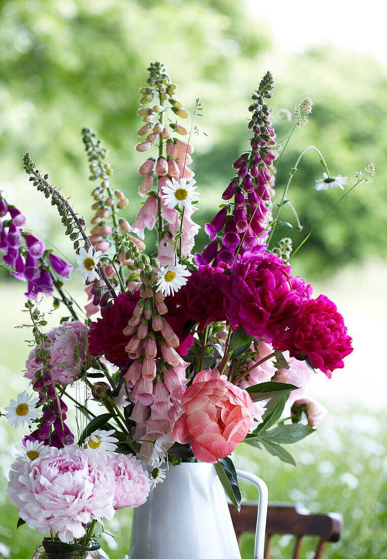 Picknickvase mit Fingerhut und anderen Blumen auf dem Tisch