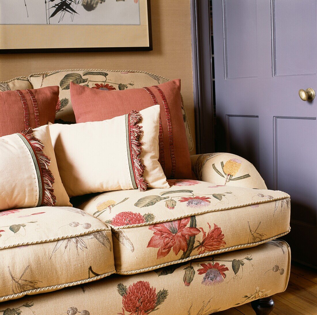 Upholstered floral sofa with cushions in a living room