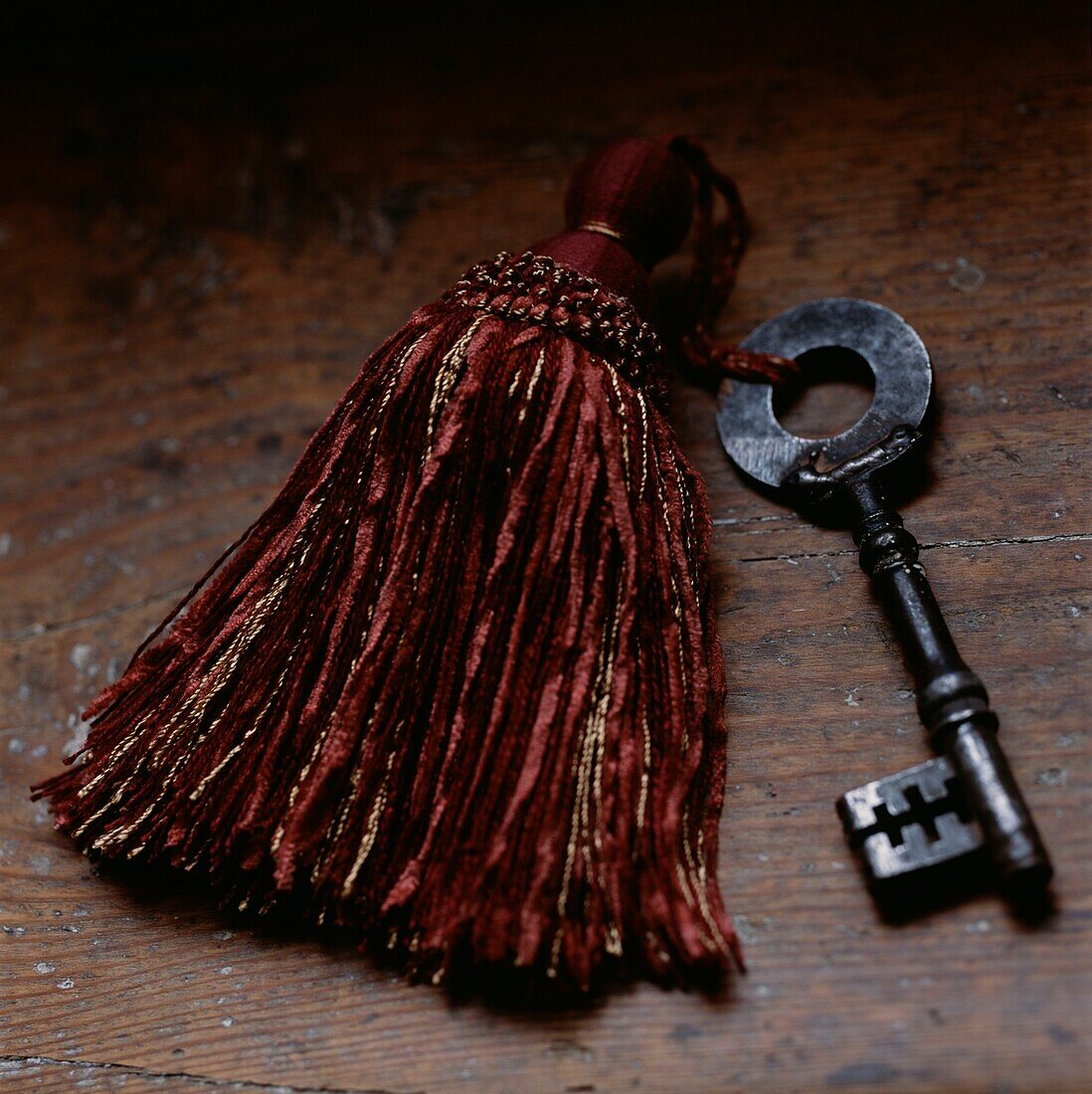 Red tassel attached to a vintage key