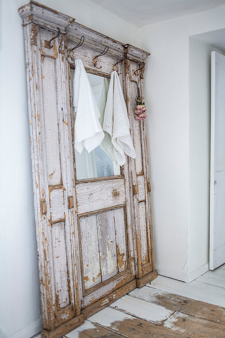 Architectural salvage used as a towel rail in white Scandi style bathroom
