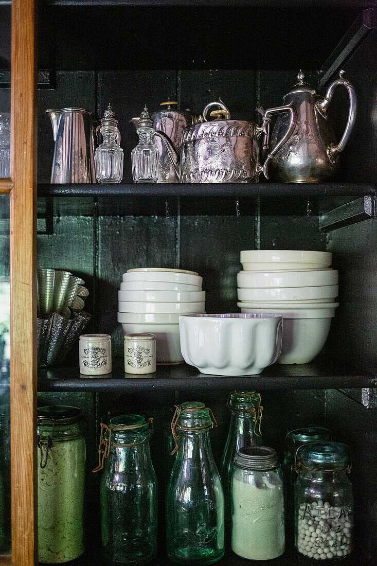 Crockery and glassware in vintage cupboard
