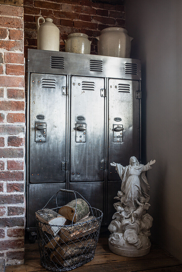 Reclaimed industrial locker unit in Suffolk cottage with stone jars and a white statuette