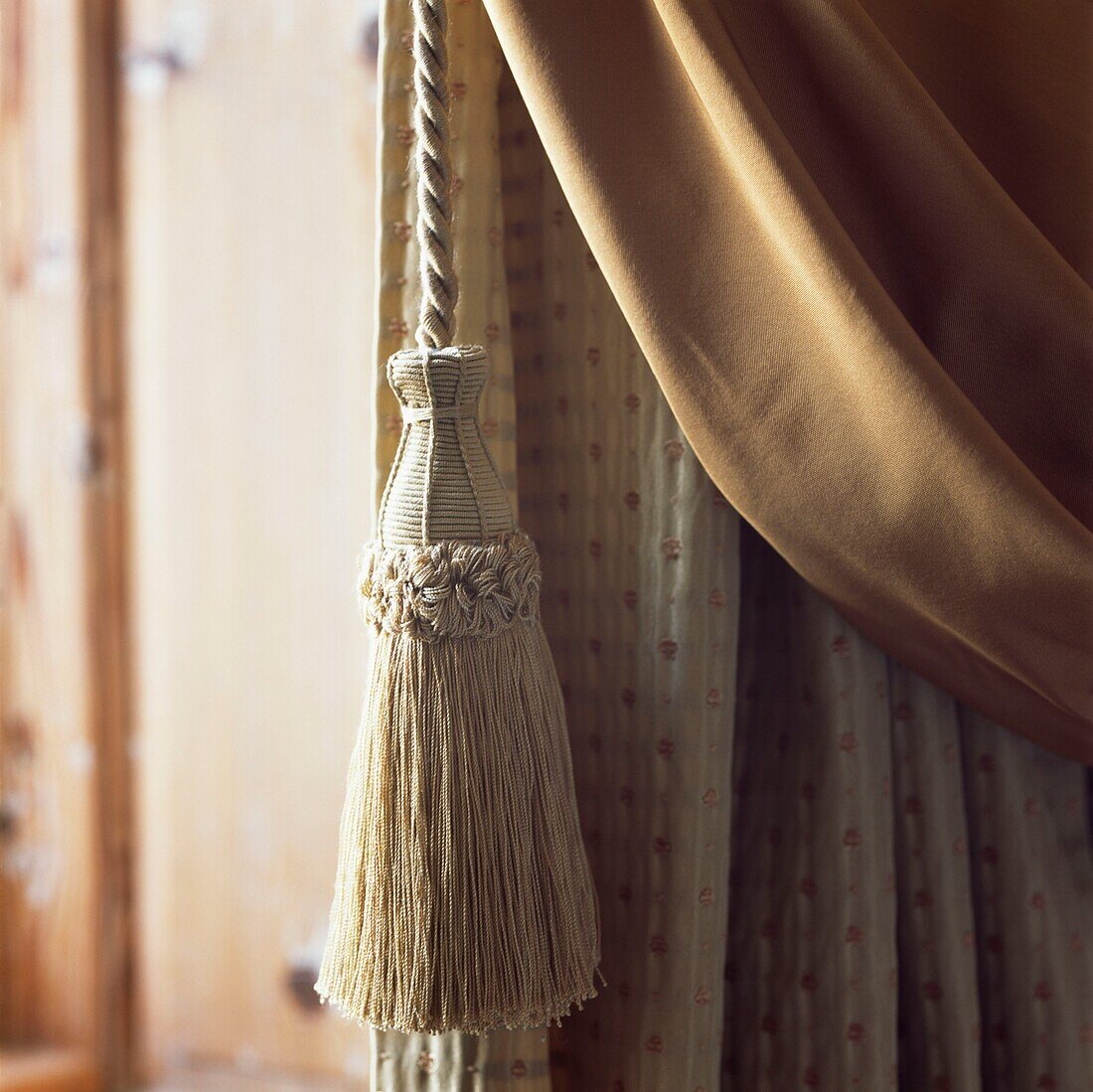 Window treatment curtain and tieback in golden colours