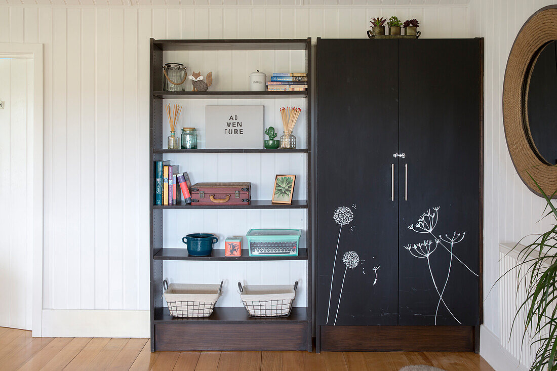 Black shelving unit with armoire and open shelves