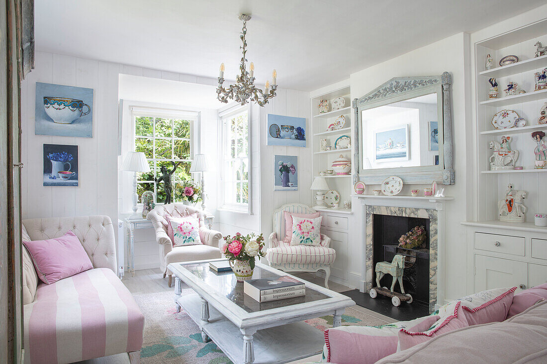 Romantically furnished living room in white and pink with floral accents