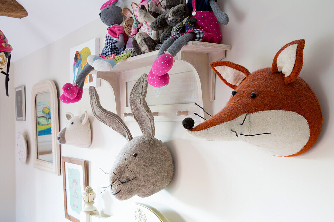 Plush animal heads on wall in child's bedroom