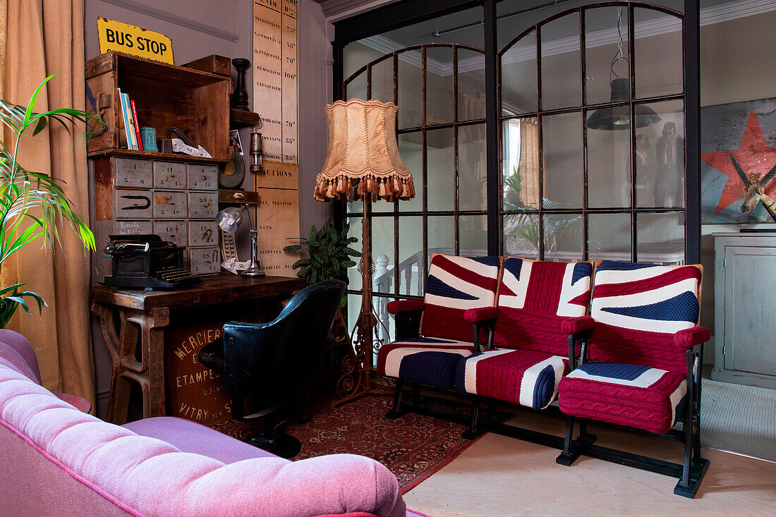 Three seater with Union Jack cover in front of industrial glass wall in the study