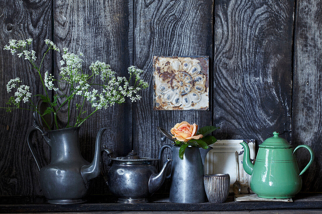 Vintage decoration with metal jugs and flowers