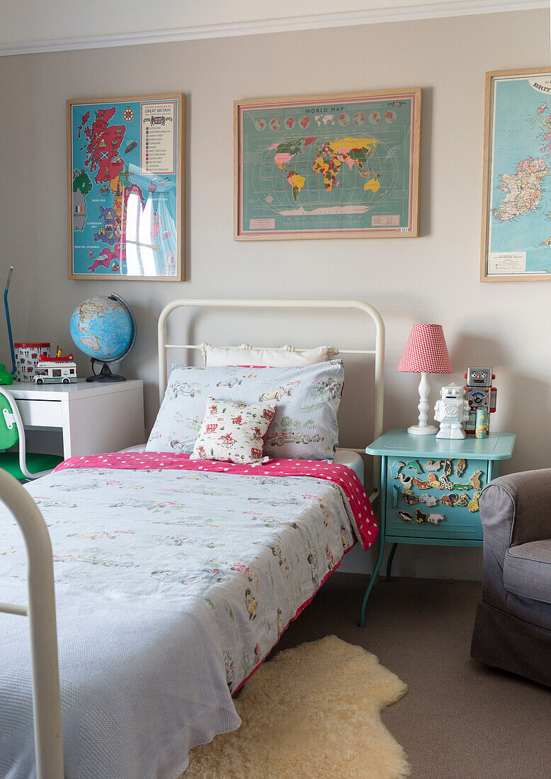 Children's room with world map decoration, bed and globe on desk