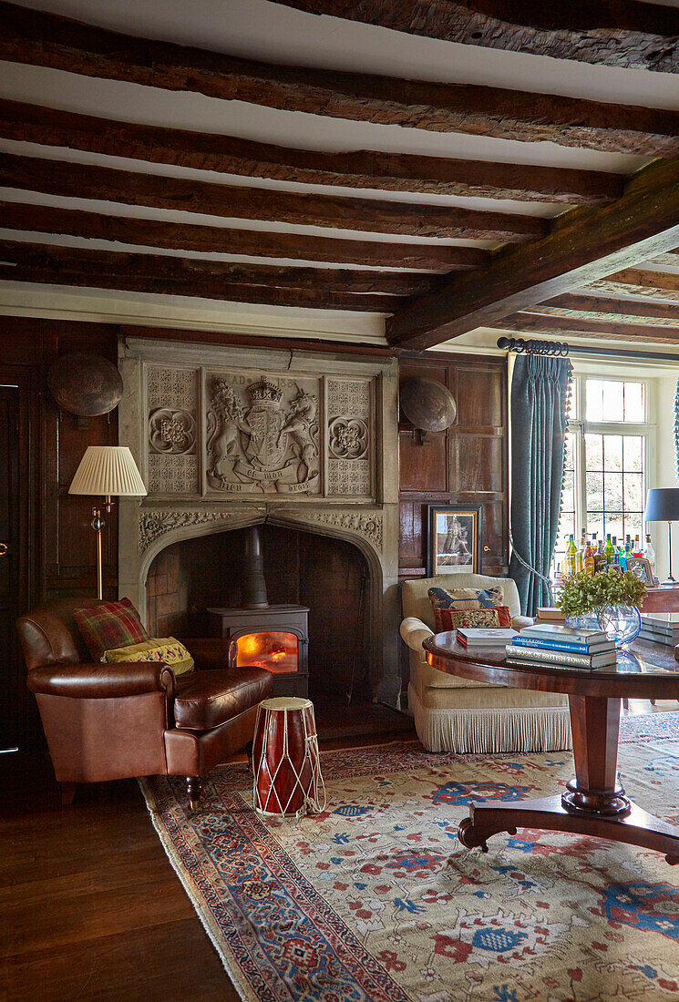 Lounge with leather armchairs in front of a fireplace