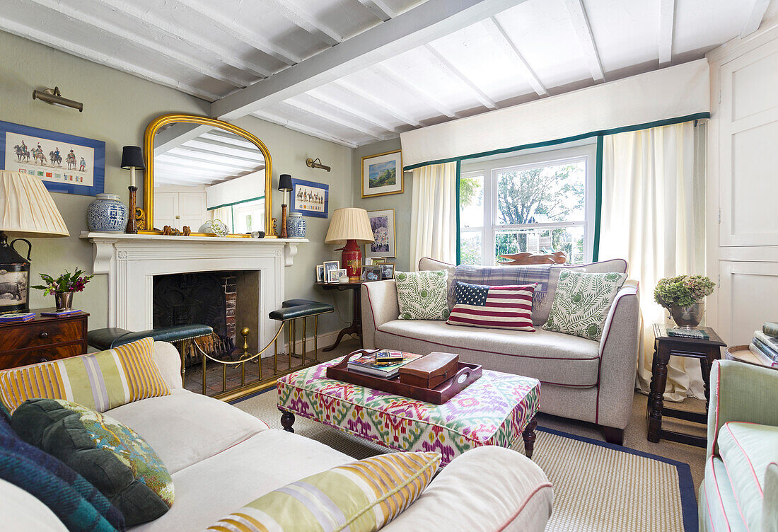 Living room with fireplace, patterned textiles and mirror