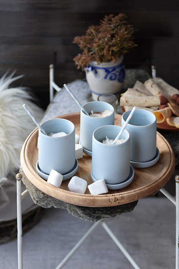 Hot chocolate with marshmallows on wooden tray, winter table decoration