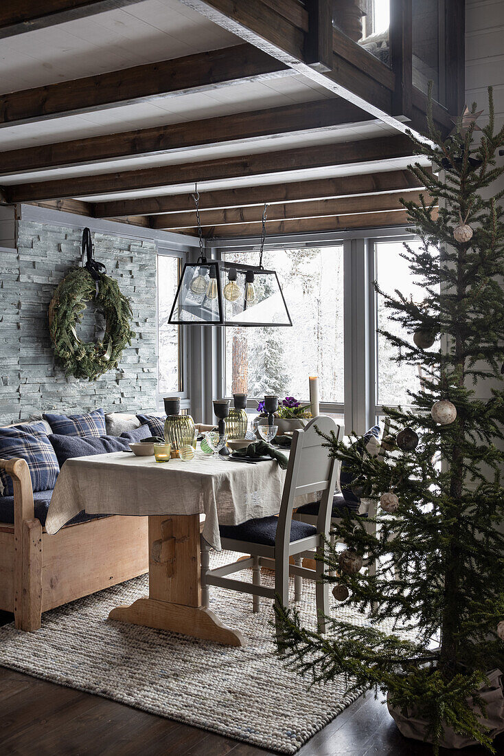 Rustic dining area with wooden furniture and Christmas decorations