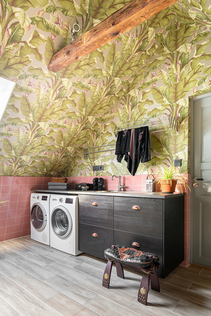 Laundry room with plant pattern wallpaper and pink tiles