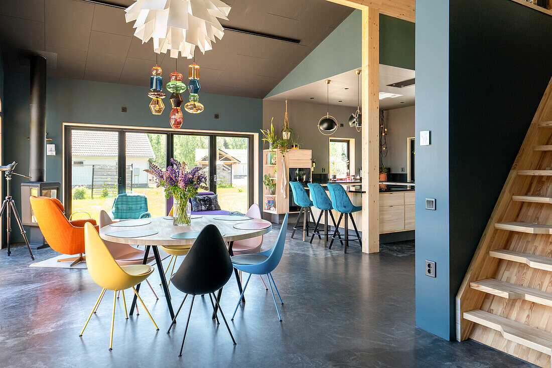 Modern dining area with colourful chairs and pendant lights