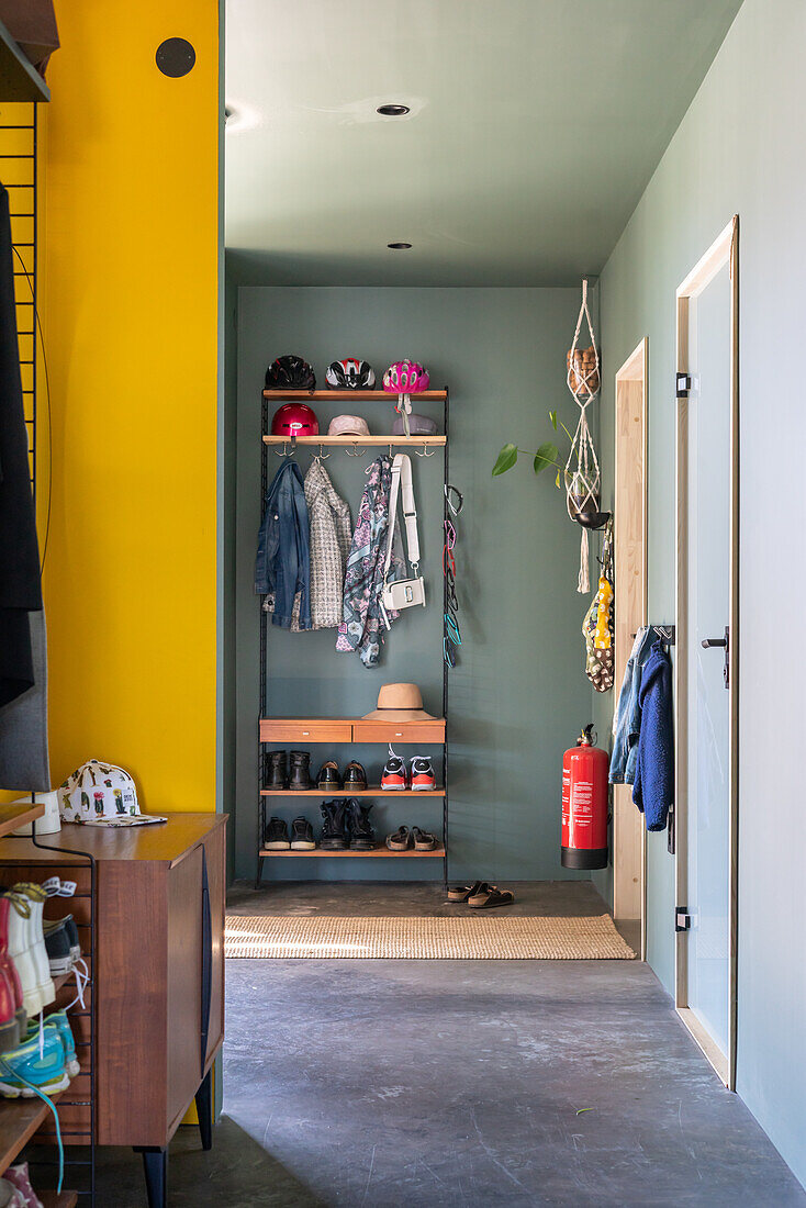 Hallway with wardrobe, shoe rack and green walls