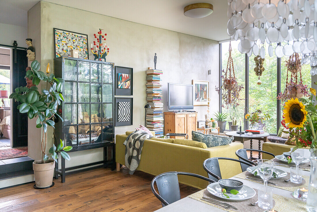 Living room with furniture mix, flowers and plants