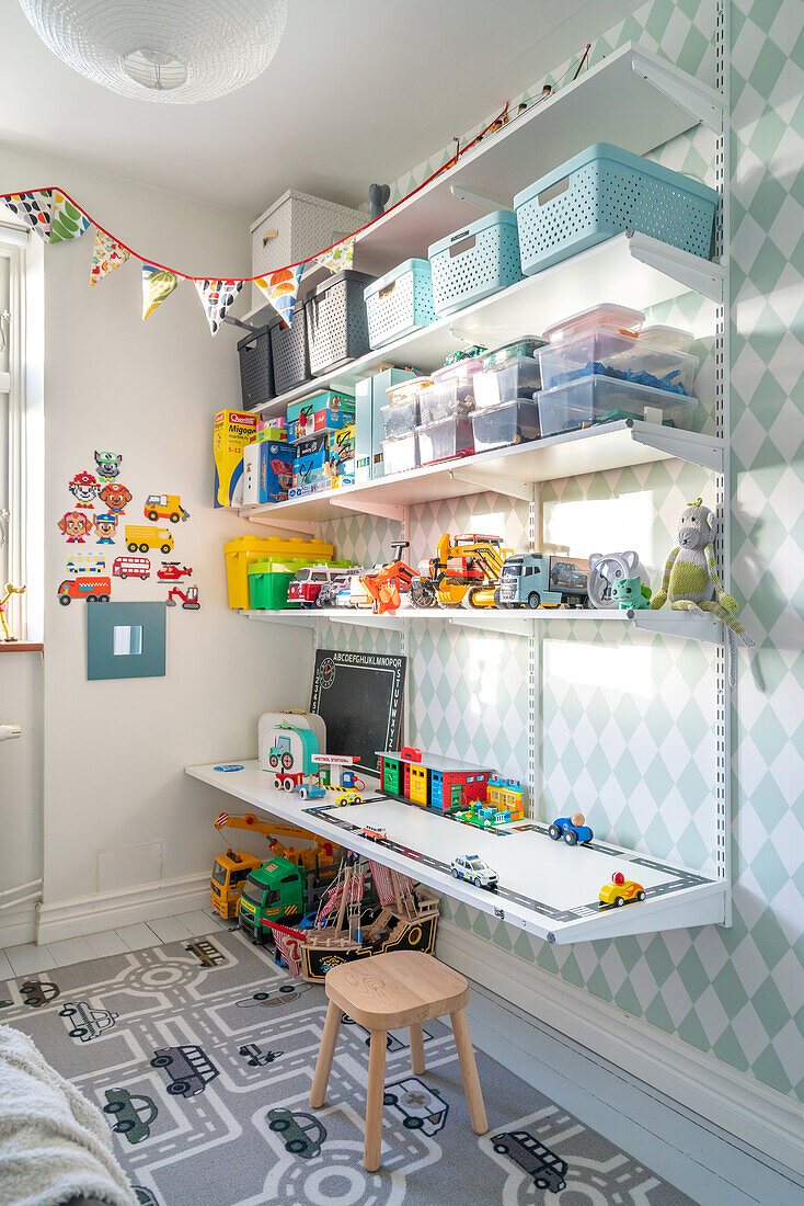 Children's room with wall shelves, toy storage and play mat with cars and roads