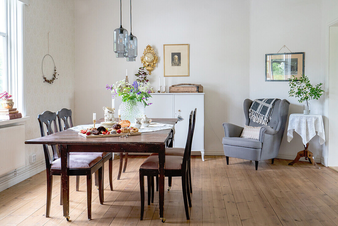 Set table and vintage furniture in the bright dining room