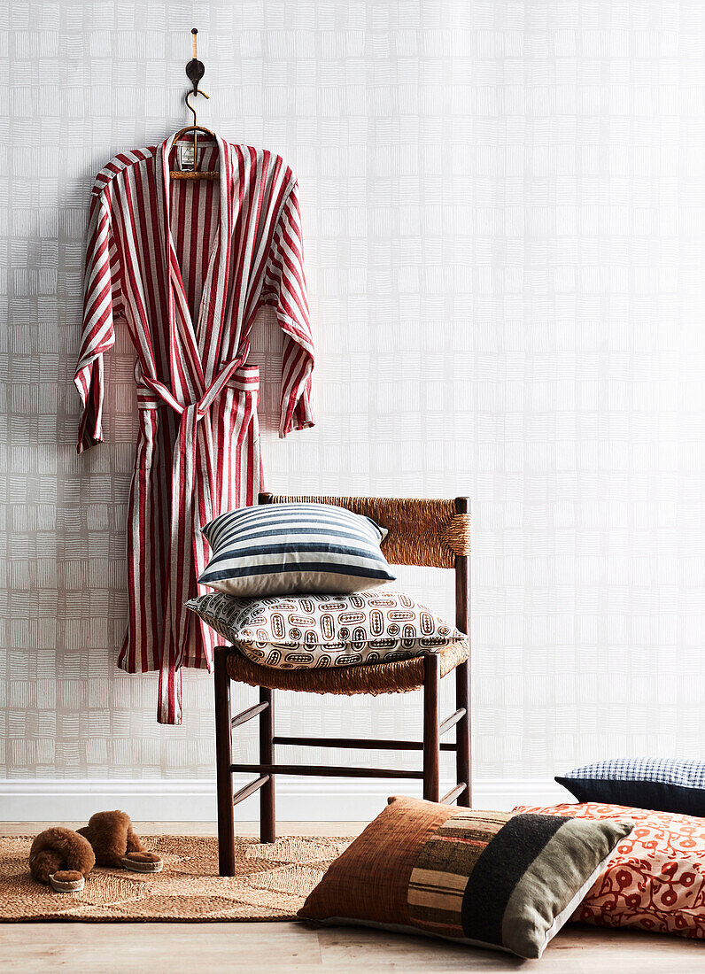 Red and white striped bathrobe, chair with patterned cushions